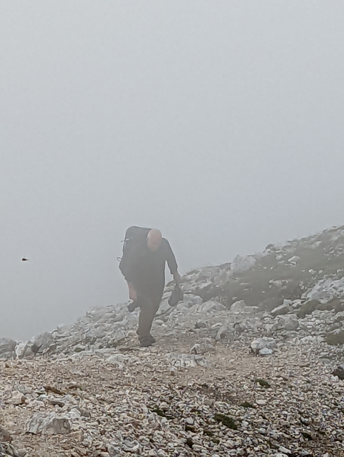 a hiker walking in the mist